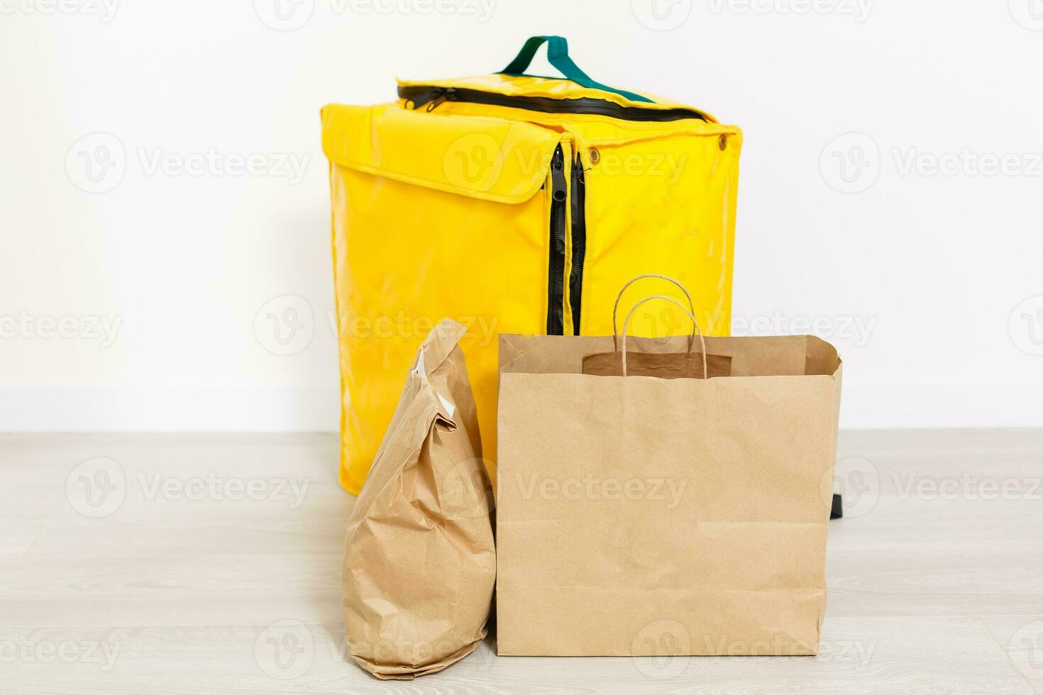 Courier with thermo bag on customer's house. Food delivery service photo