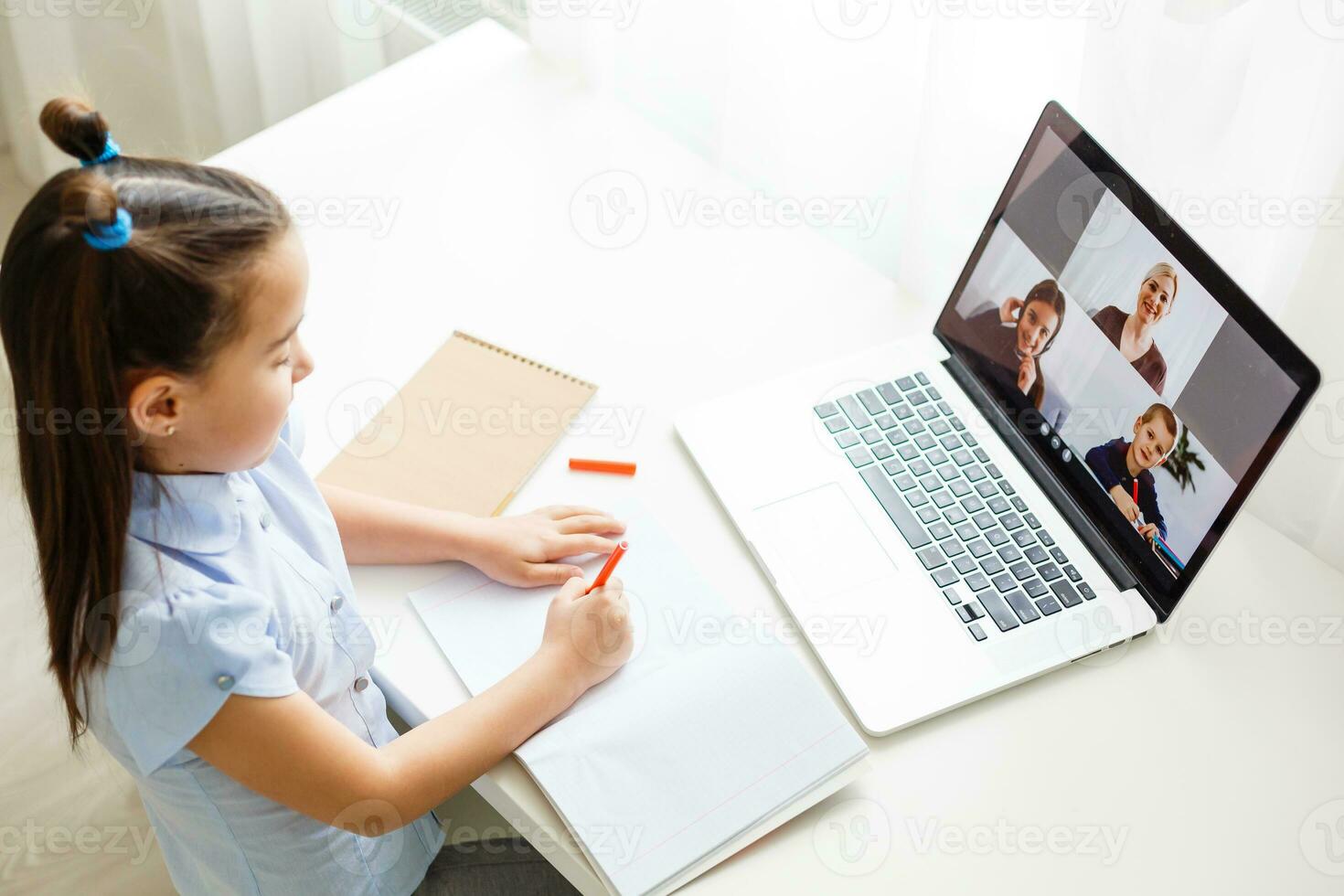 Pretty stylish schoolgirl studying homework math during her online lesson at home, social distance during quarantine, self-isolation, online education concept, home schooler photo