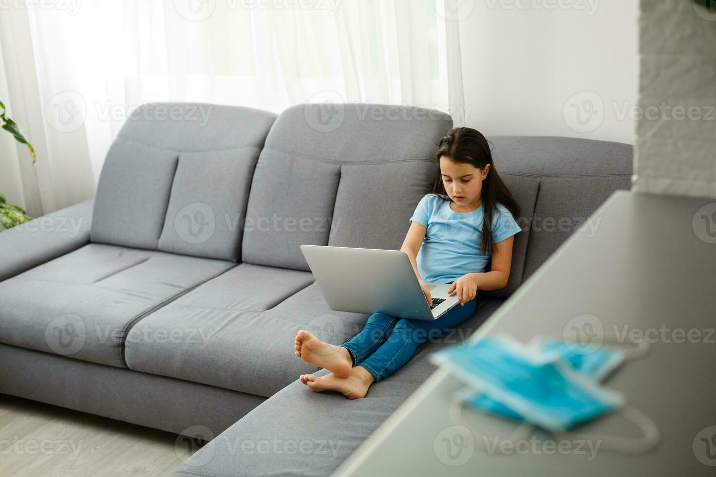 Little Girl Using Digital Laptop E-learning Concept. little girl children using laptop computer, studying through online e-learning system. photo
