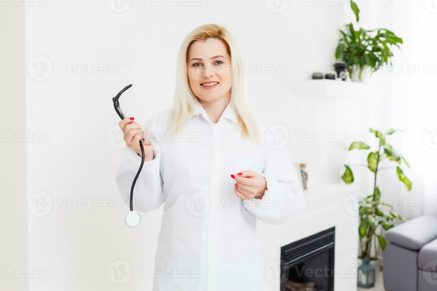 Portrait of a beautiful happy female doctor standing in the hospital photo