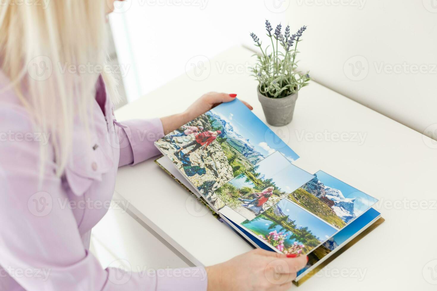 Young blond woman holding a photo album. photobook