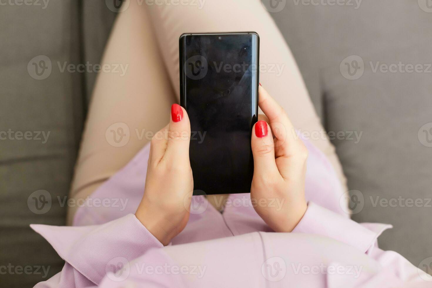 beautiful young woman using an application to send an sms message in her smartphone device while eating a salad photo