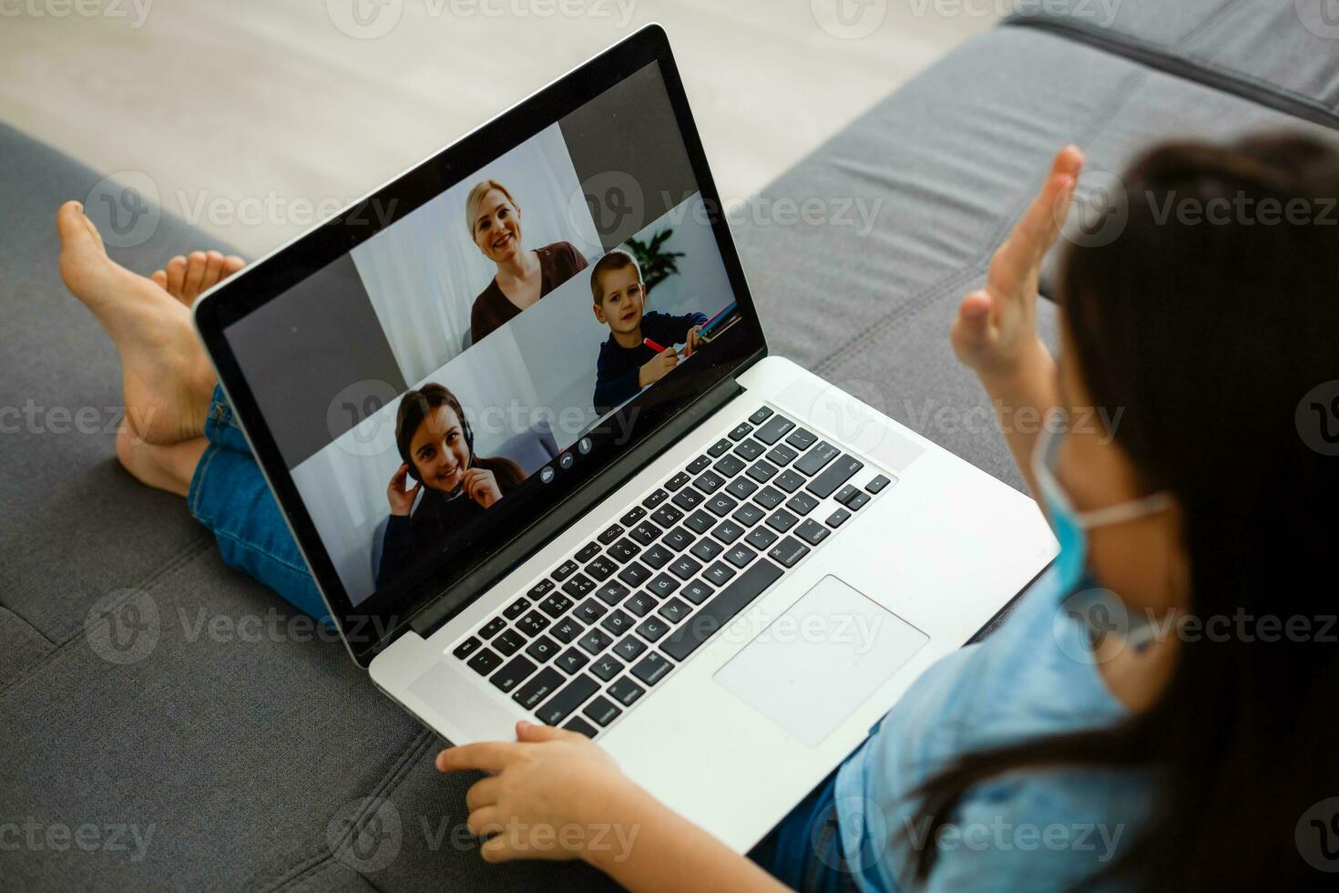 Head shot close up portrait of happy small pupil learning at home. Smiling little child girl enjoying doing lessons in living room. Smart kid schoolgirl looking at camera, studying remotely online. photo