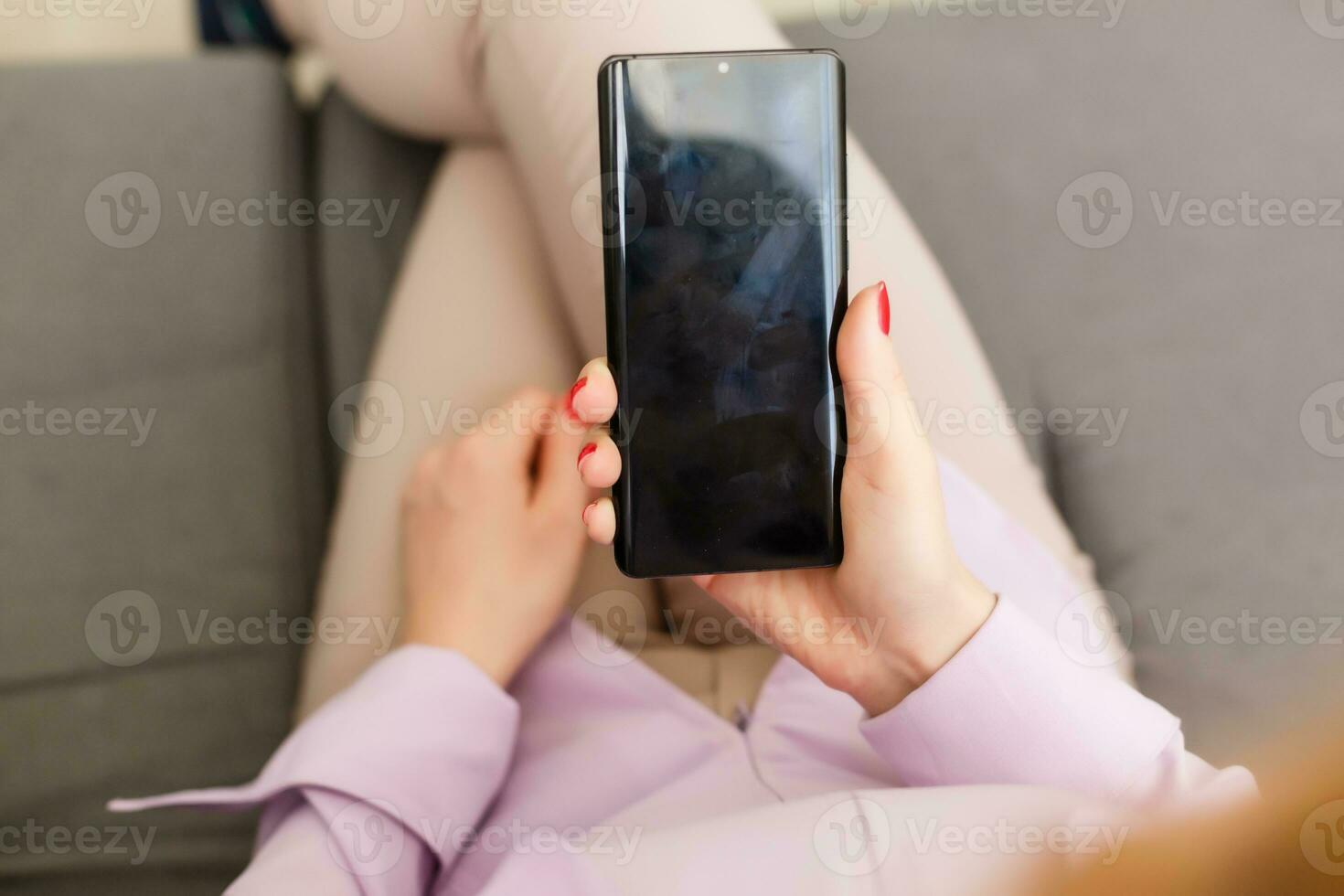 Young woman using apps on a mobile touchscreen smartphone. Concept for using technology, shopping online, mobile apps, texting, addiction, swipe up, swipe down. photo