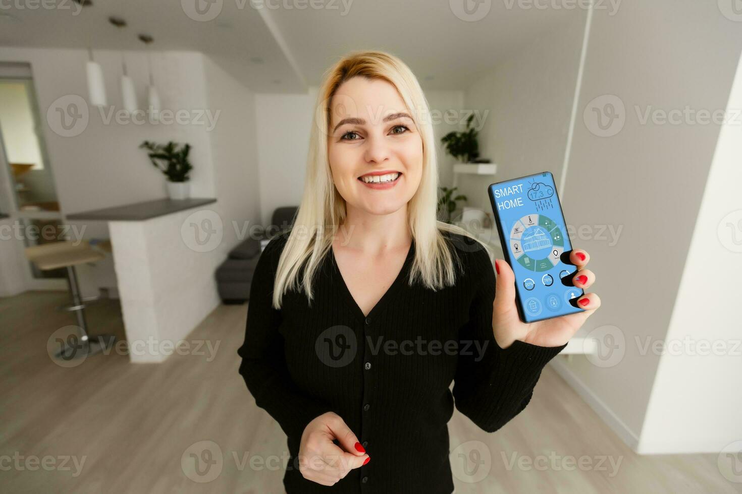 woman hand holding the phone with system clever house photo