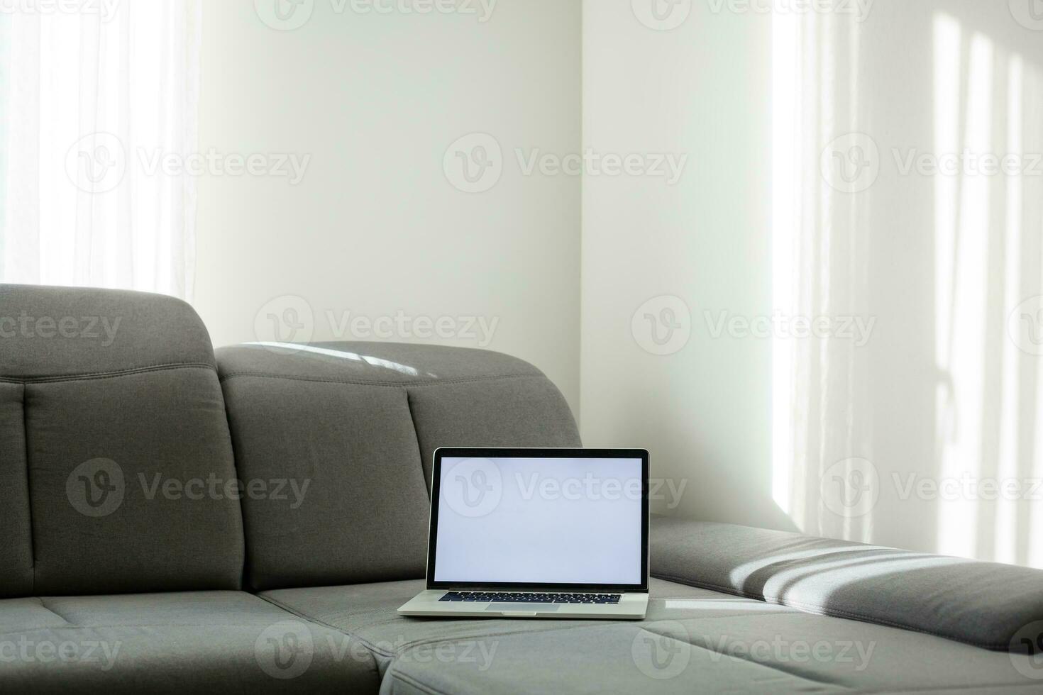 Modern interior. Comfortable workplace. The laptop is on the couch photo