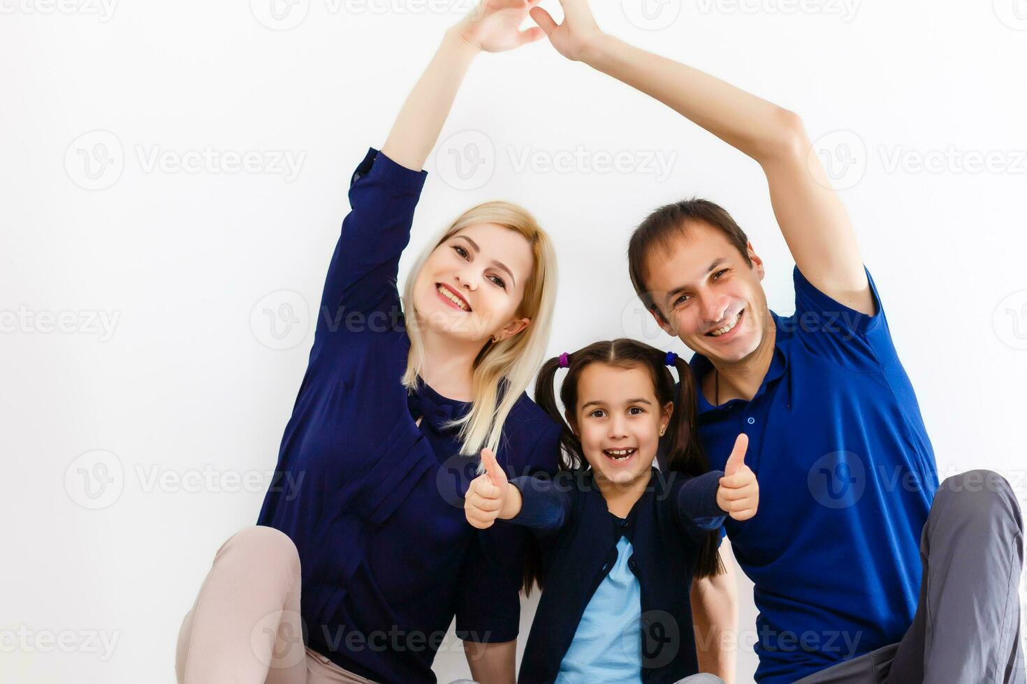 Portrait of happy family of three looking at camera with smiles photo