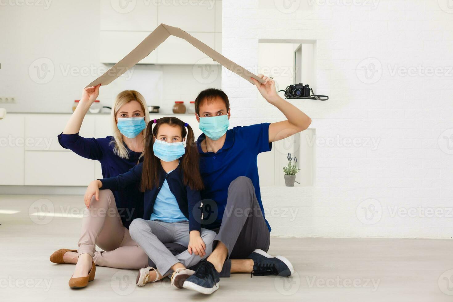 father, mother and daughter wearing protective masks on white background. photo