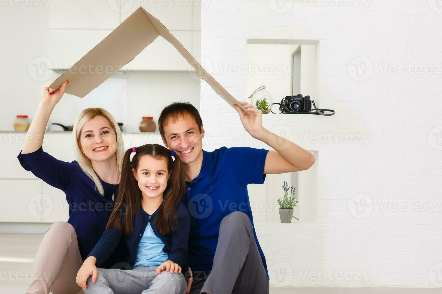 concept housing a young family. Mother father and child in new house with a roof photo