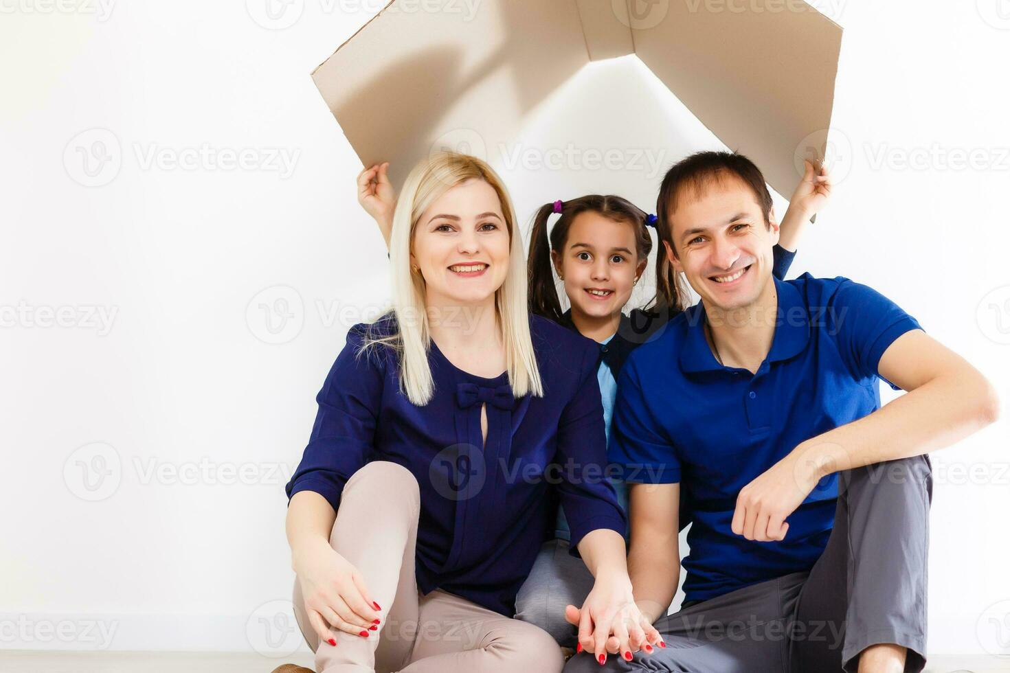Happy to be a family. Happy family smiling while sitting indoors photo