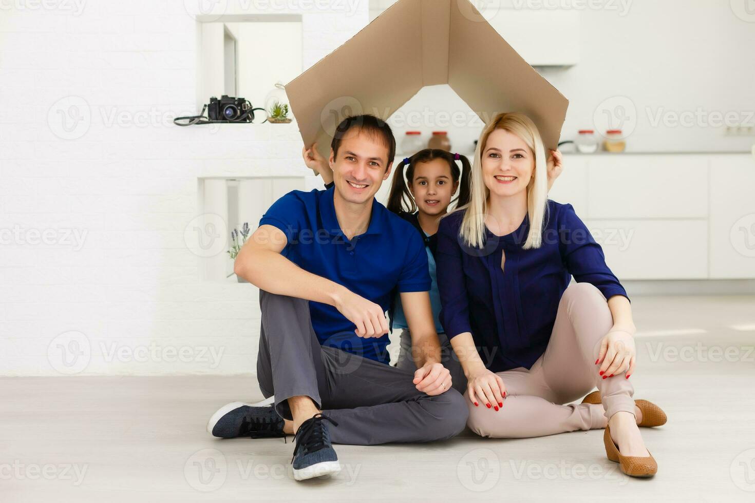 concept housing a young family. Mother father and child in new house with a roof photo