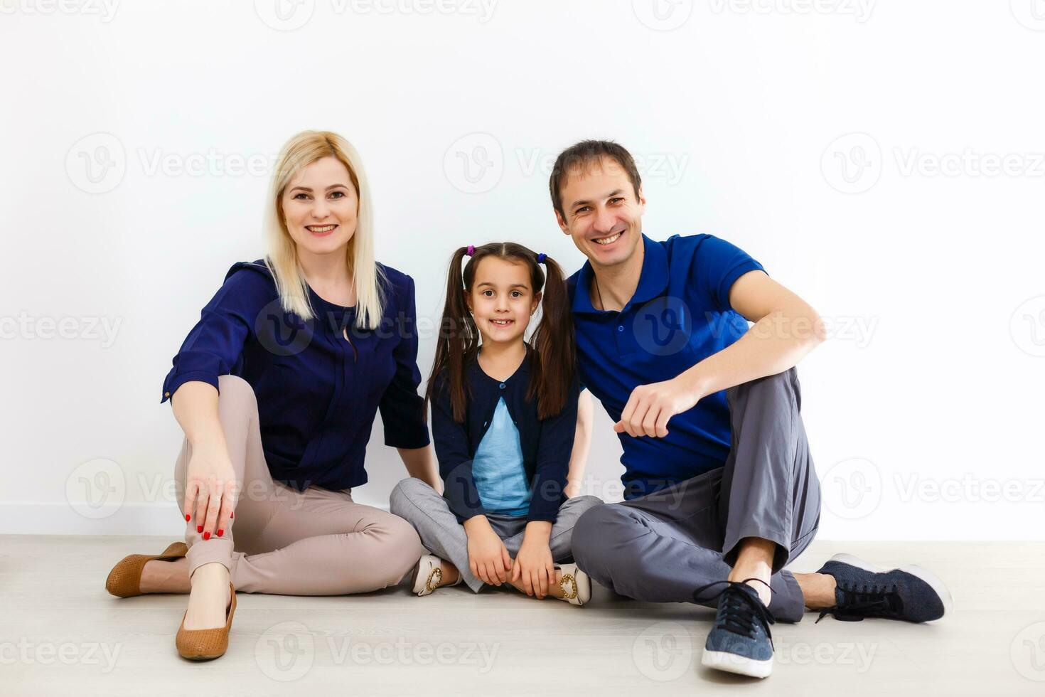 Portrait of happy family of three looking at camera with smiles photo