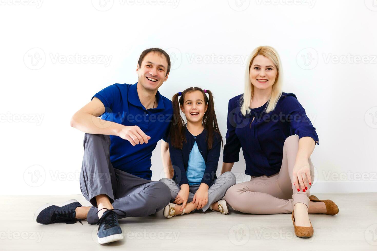 Happy to be a family. Happy family smiling while sitting indoors photo