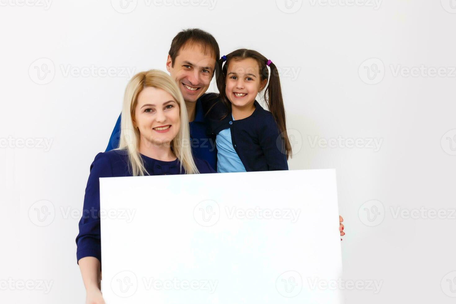 family holds holds a large photo canvas