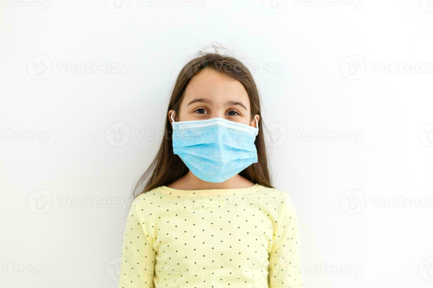 Masked child - protection against influenza virus. Little Caucasian girl wearing mask for protect pm2.5. Biological weapons. baby on a gray background with copy space. epidemic, pandemic. photo