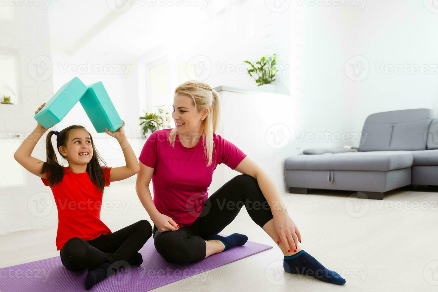 family mother and child daughter are engaged in fitness, yoga, exercise at home photo