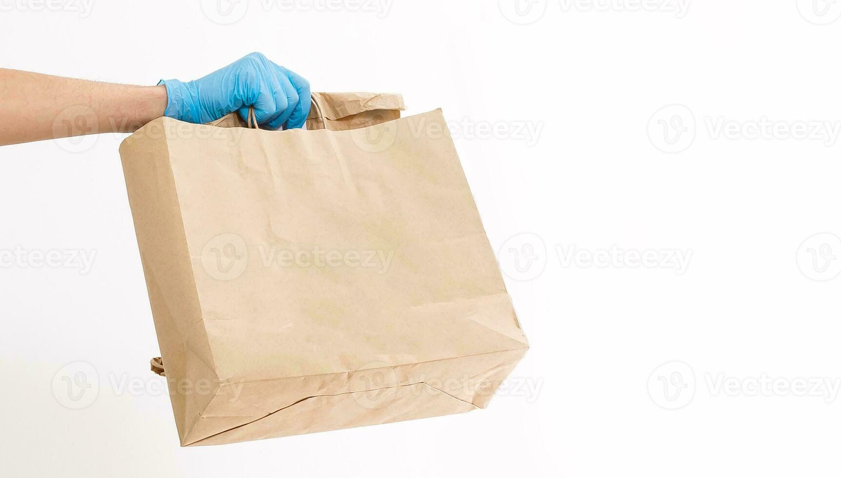 A man in protective mask is delivering food on a bicycle. Online shopping and Express delivery . Quarantine photo