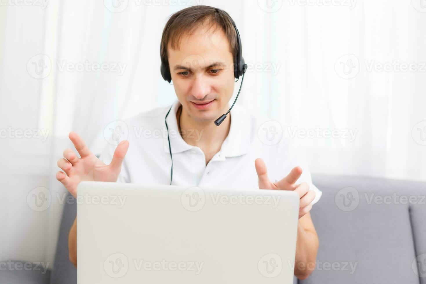 Happy Businessman in the office on the phone, headset, Skype. looking camera photo