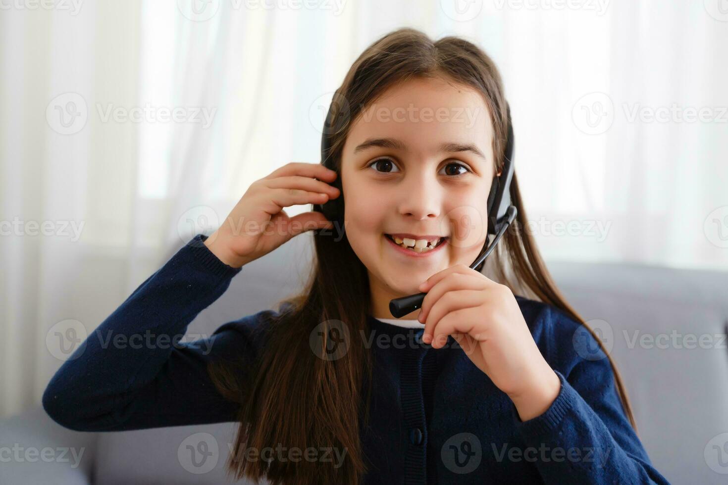 School girl is studying online. Home schooling. Distance education. The girl raises her hand to answer the teacher's question. photo