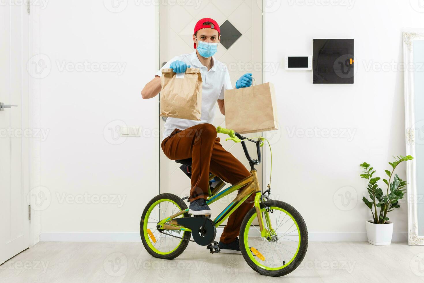 The courier delivers a box of food while the coronavirus pandemic, horizontal orientation photo