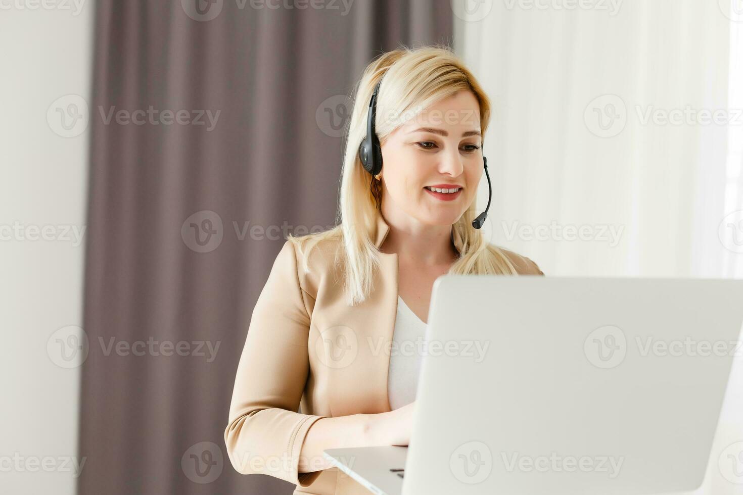 Cheerful woman wear headset laugh using laptop video stream conference call teach online, happy ethnic girl student gamer tutor have fun watch webinar web cam education entertainment concept photo