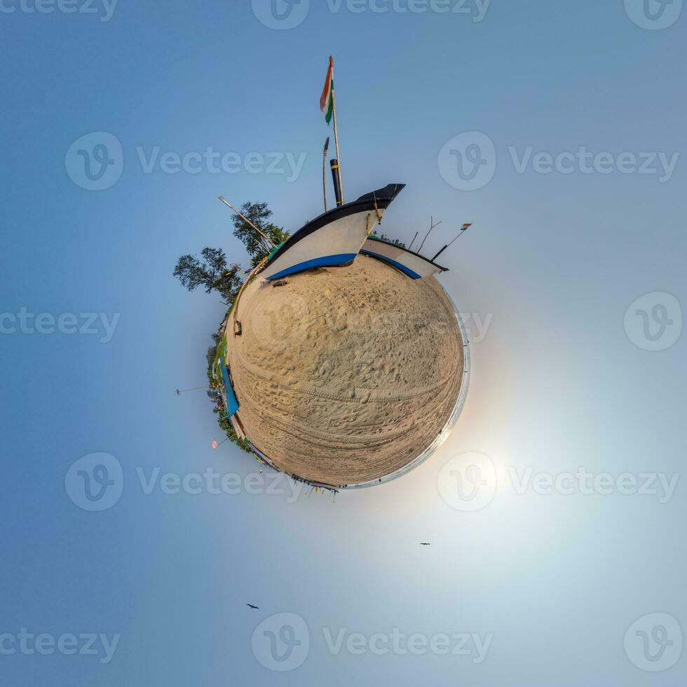 coconut trees in jungle in Indian tropic village on sea shore with fisher boat on little planet in evening sky, transformation of spherical 360 panorama. photo