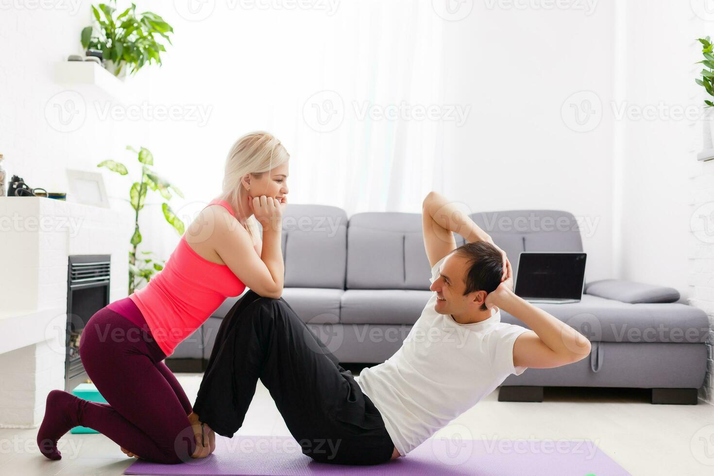 Young man and woman woman doing exercise in the sunny room photo