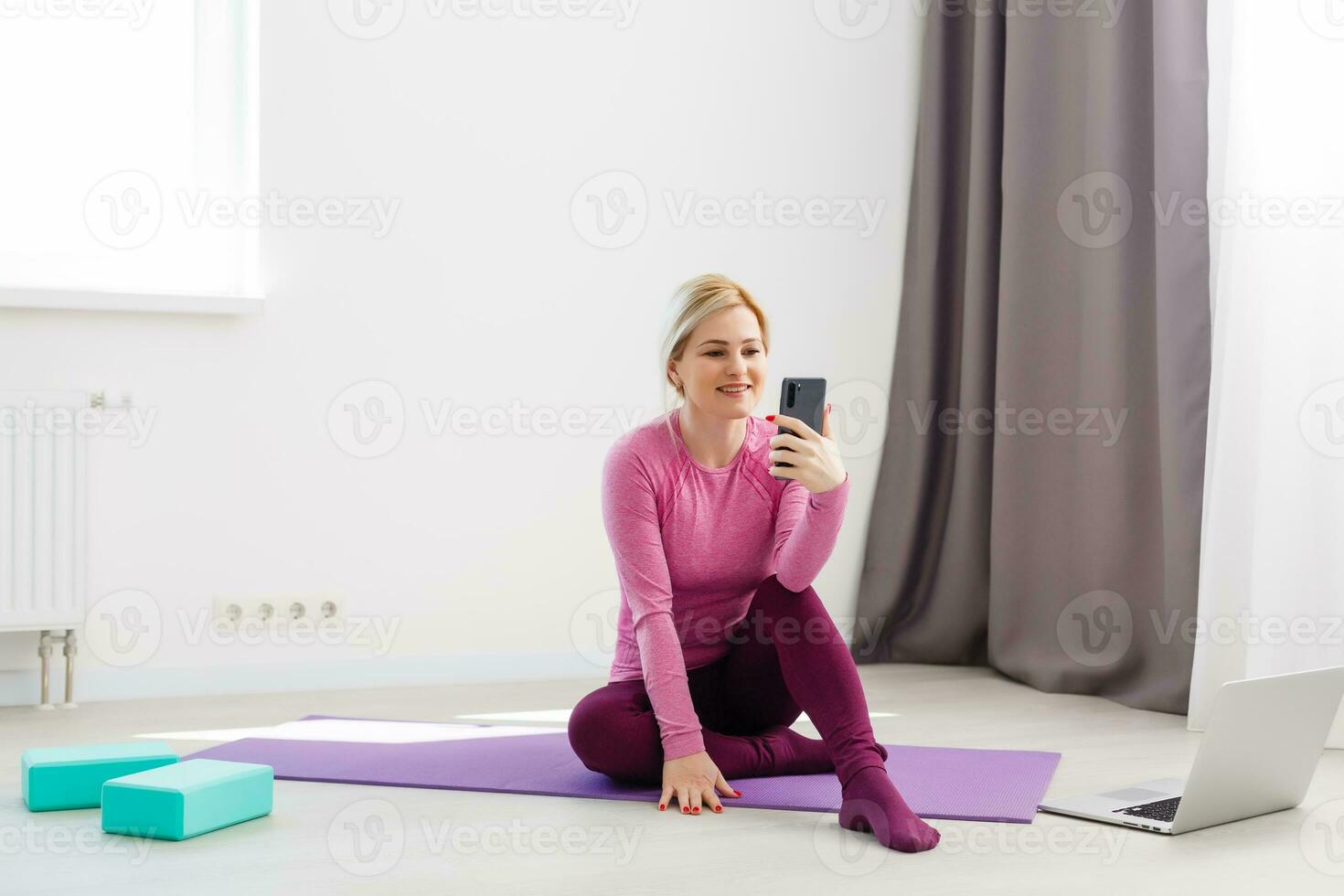 Horizontal view of a woman doing yoga at home photo