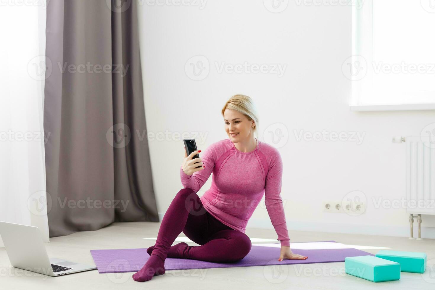 Beautiful young woman doing yoga at home. photo