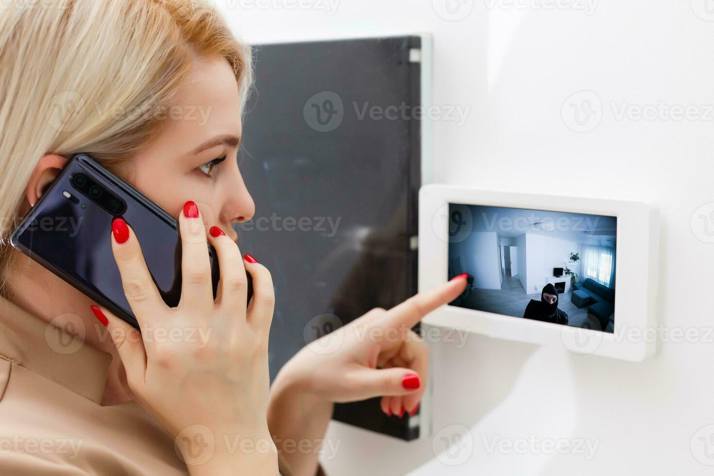 Woman dialing intercom, smart House photo