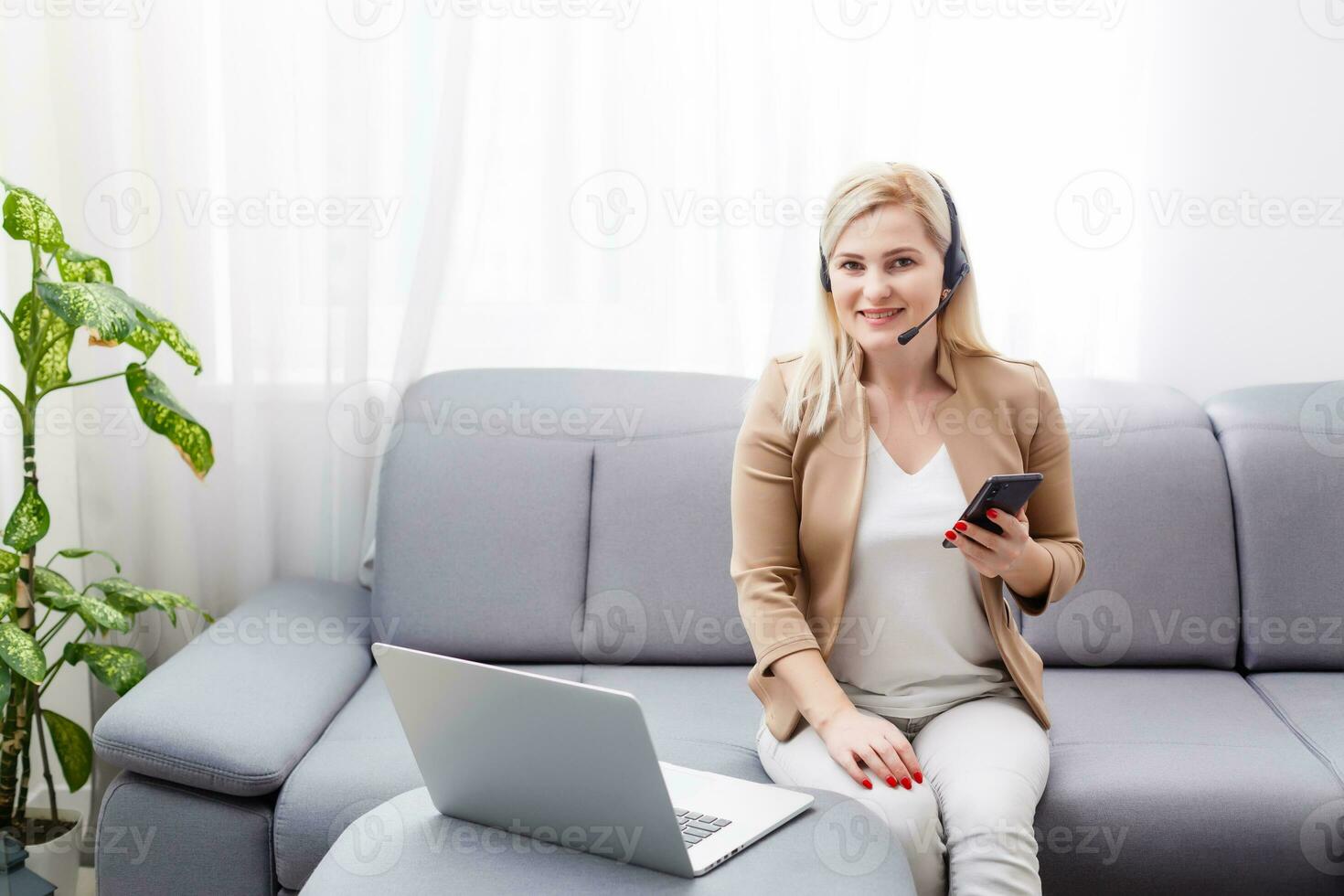 Portrait of happy smiling cheerful beautiful young support phone operator in headset, at office, with copyspace area photo