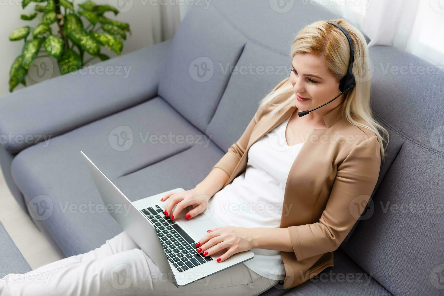 Portrait of happy smiling cheerful beautiful young support phone operator in headset, at office, with copyspace area photo