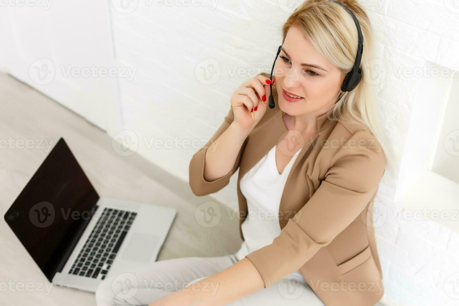 Portrait of happy smiling cheerful beautiful young support phone operator in headset, at office, with copyspace area photo