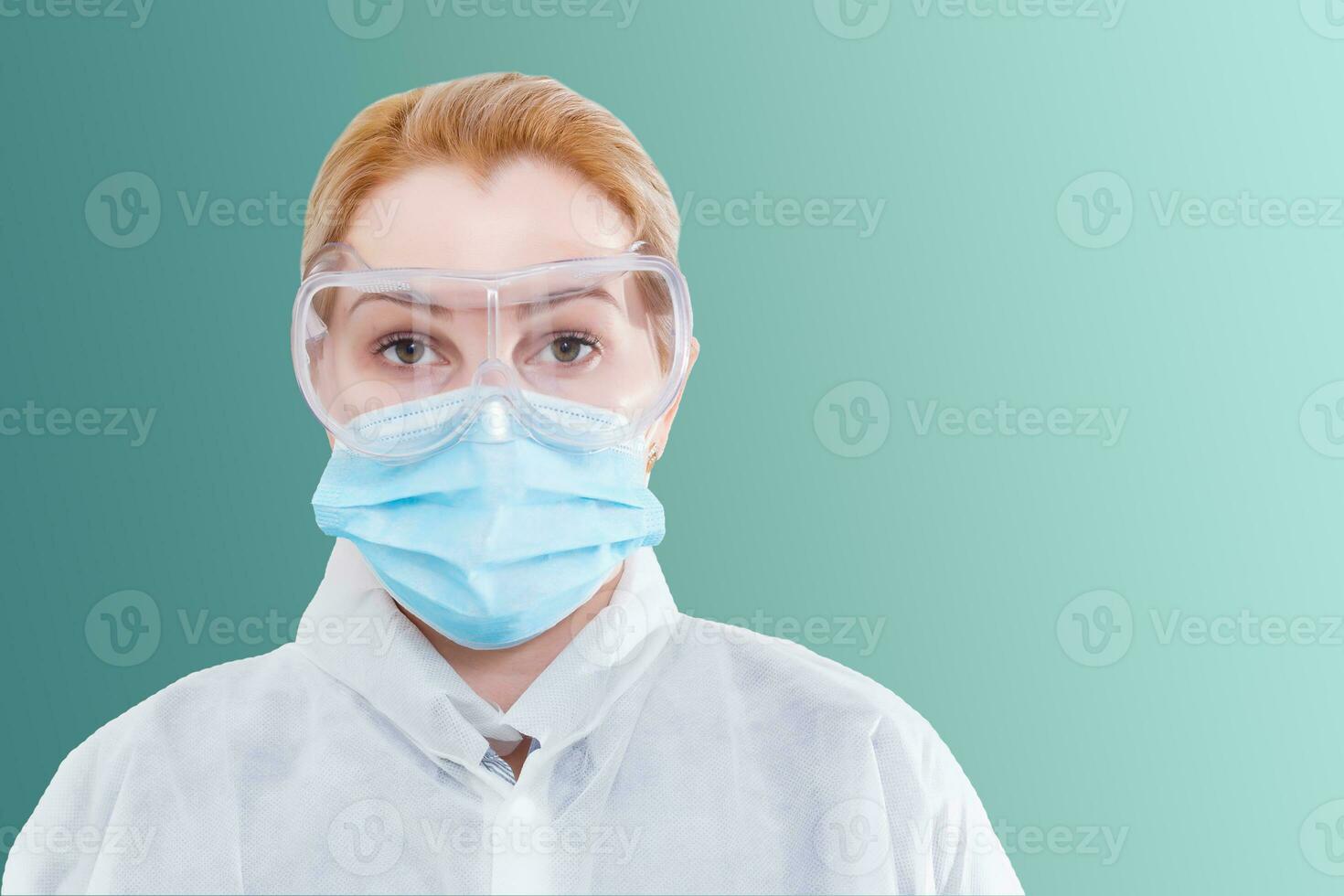 Surgeon woman in protective glasses and mask on whites background. photo
