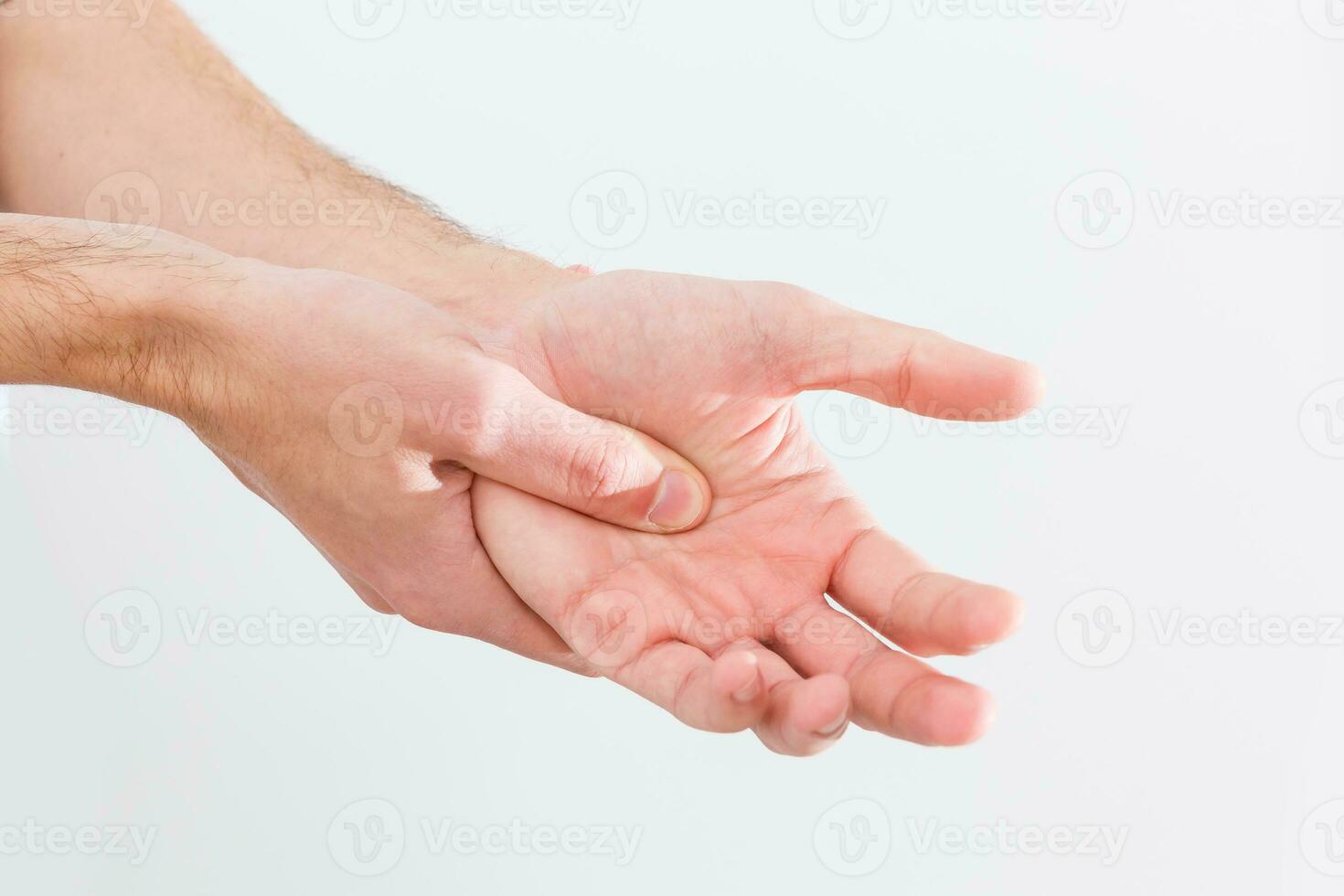 Man with painful and inflamed gout on his hand around the thumb area. photo