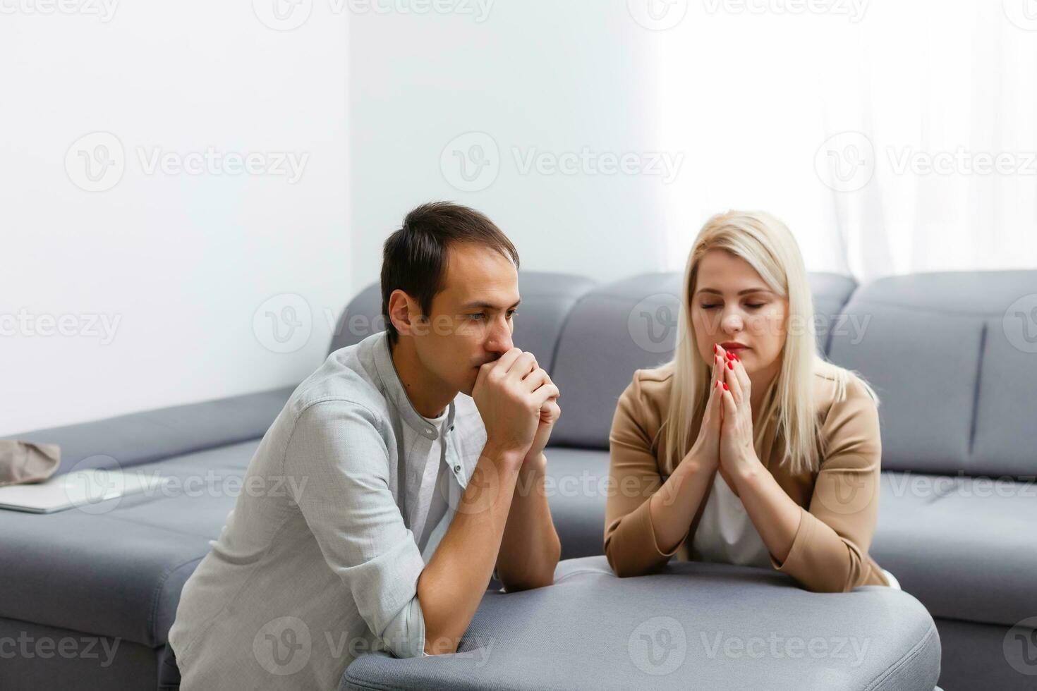 Young family praying at home photo