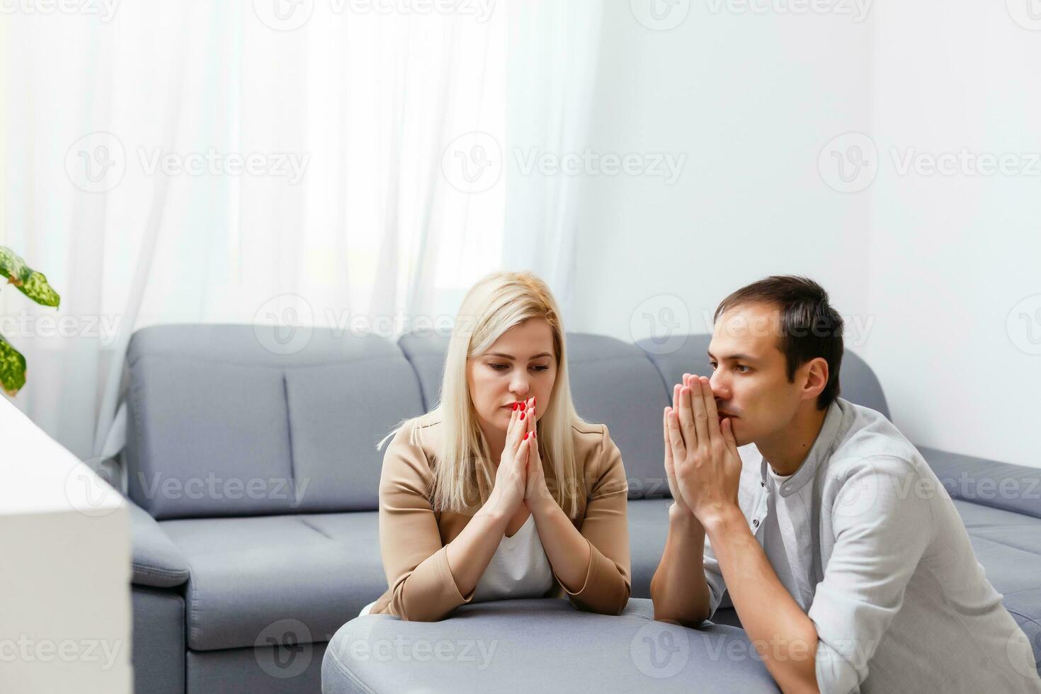 woman and man pray at home photo
