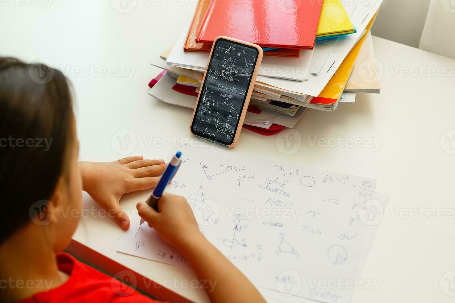 Distance learning online education, little girl writes formulas photo