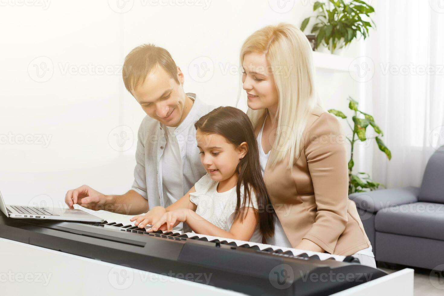 Happy family, mother, father and daughter playing piano at home, concept for family relationship. music school and music family. photo