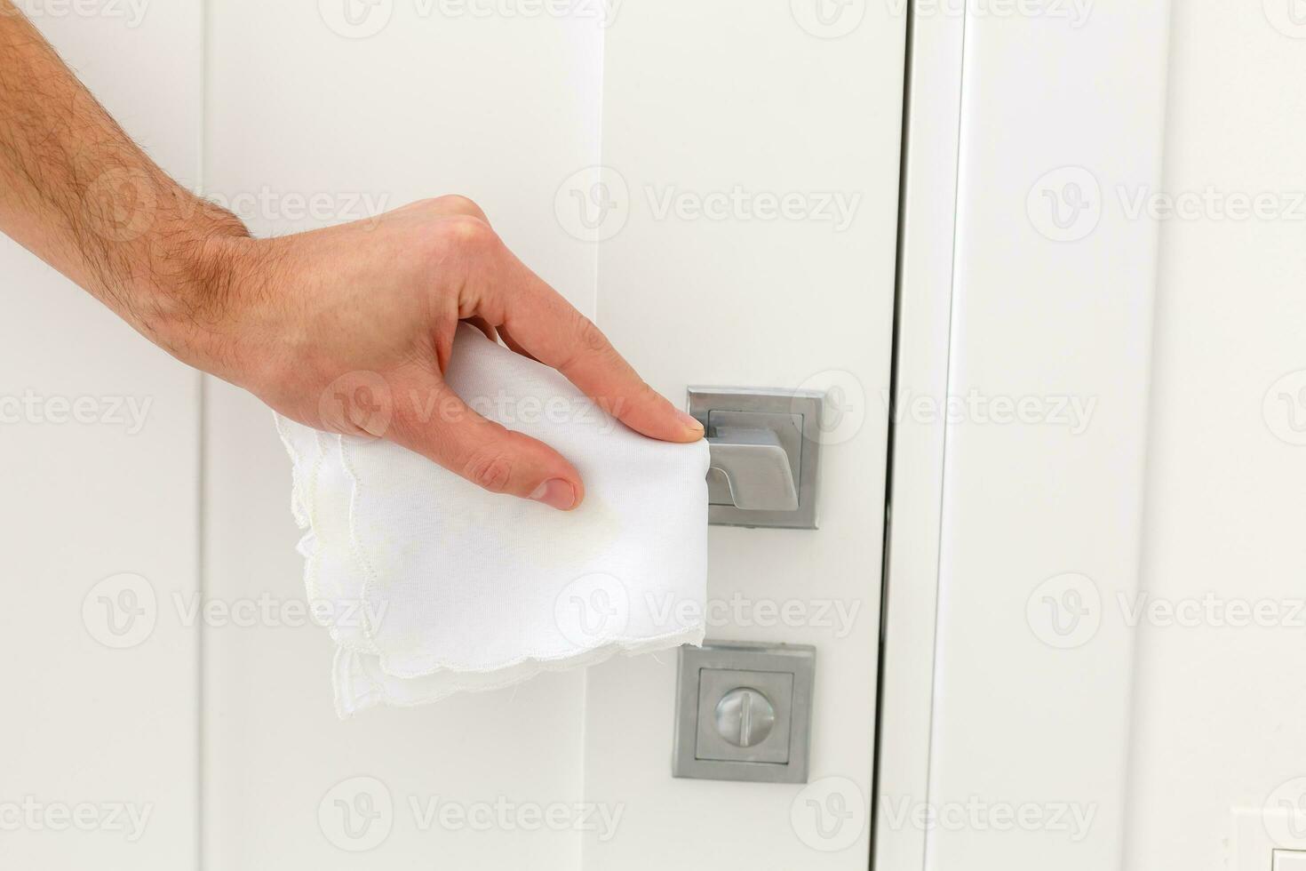 Using hand open the door with paper wipe on knob prevent covid19 virus. photo