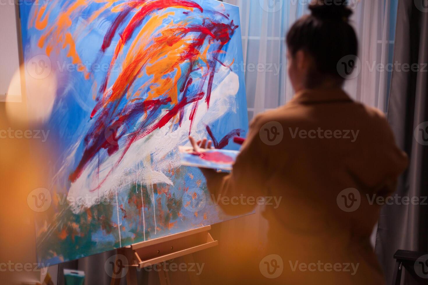 Painter creates picture in art workshop on large canvas. Modern artwork paint on canvas, creative, contemporary and successful fine art artist drawing masterpiece photo