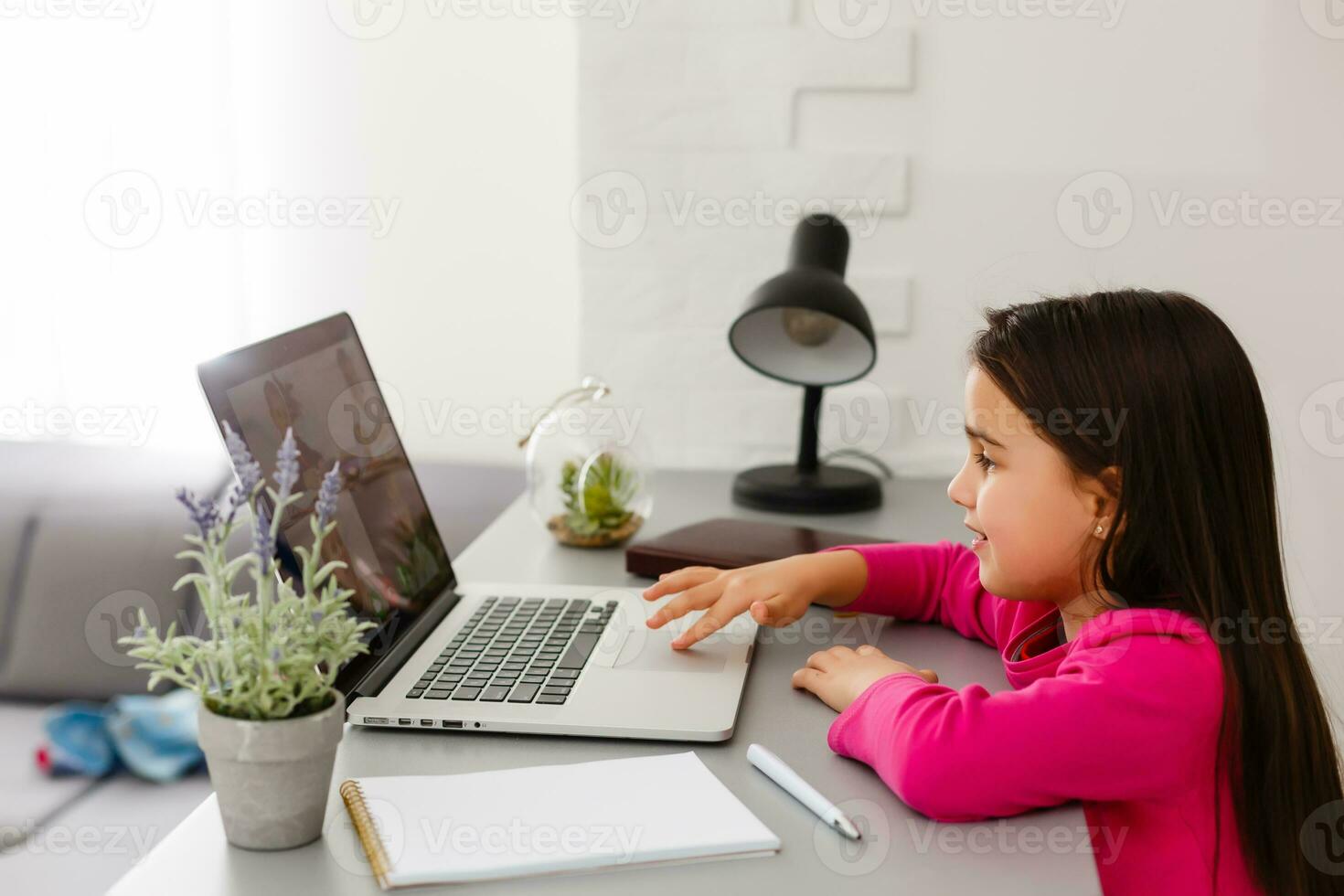little girl studying with computer photo