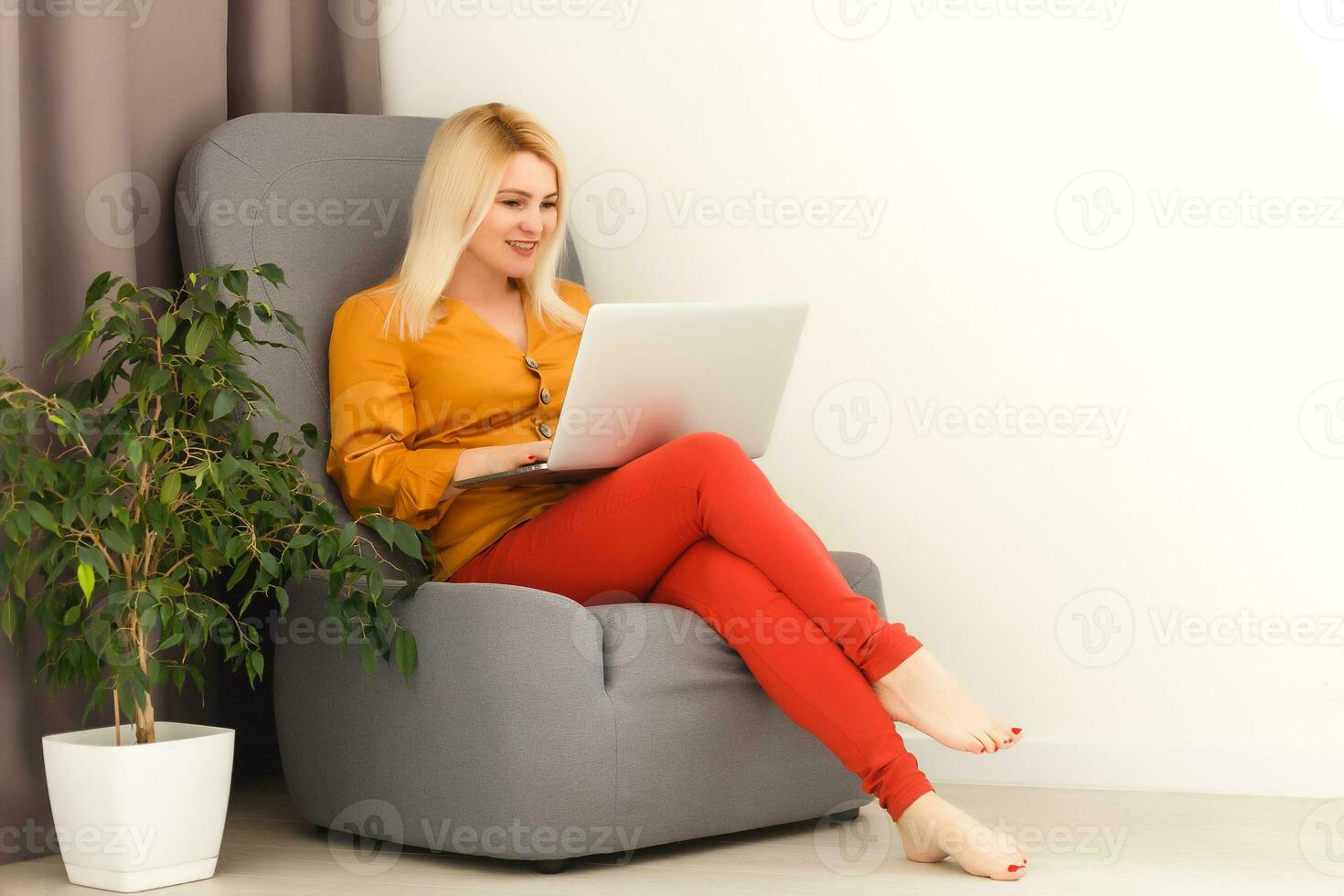 Beautiful woman reviewing her lesson with her laptop and book photo