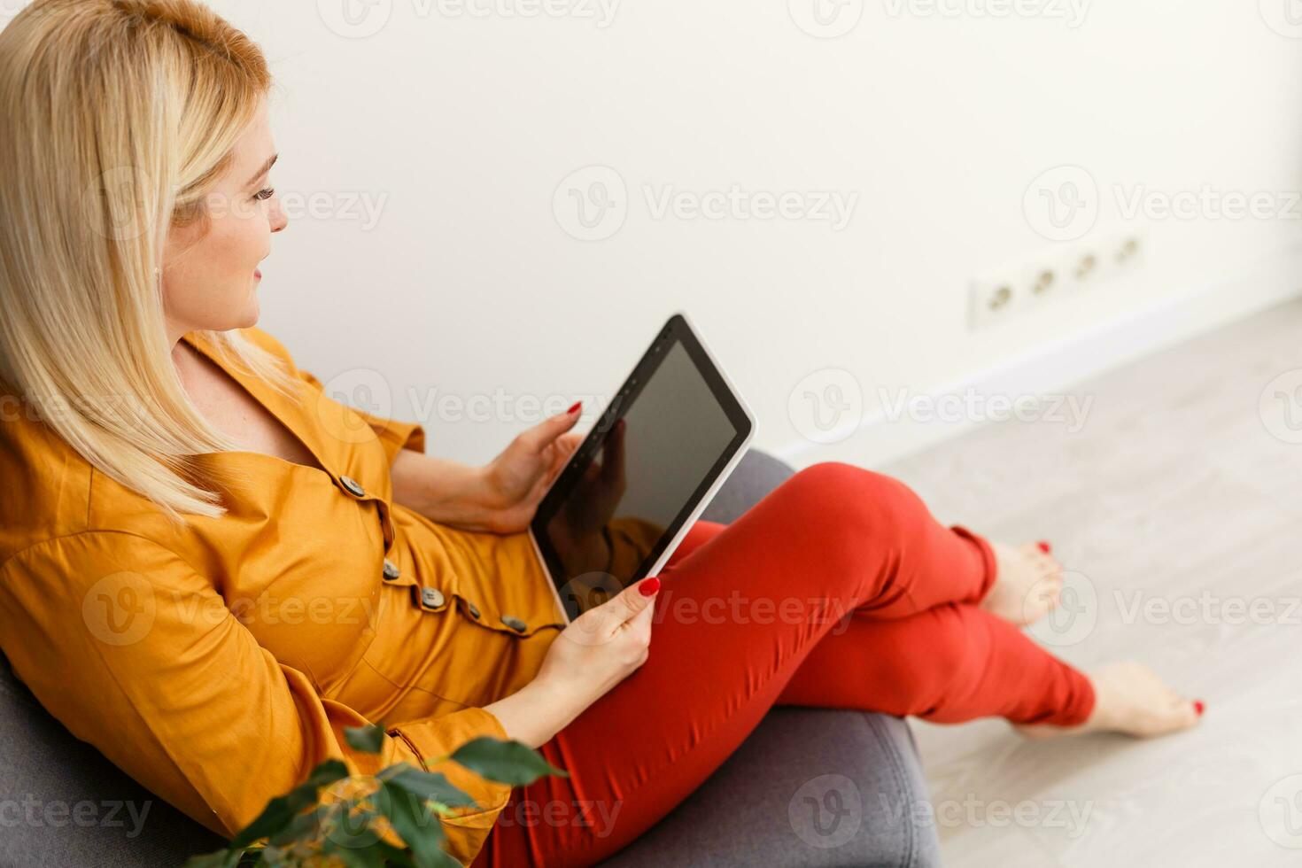Cropped image of young female student attending online lecture on laptop at desk photo