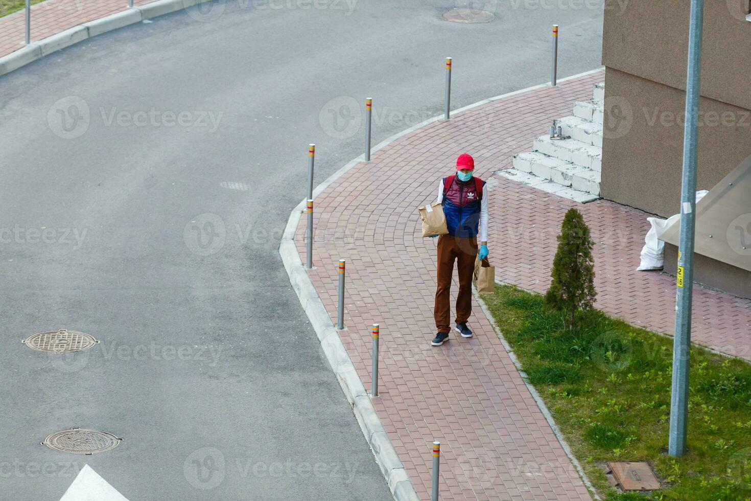 food delivery man on empty street producer of quarantine photo