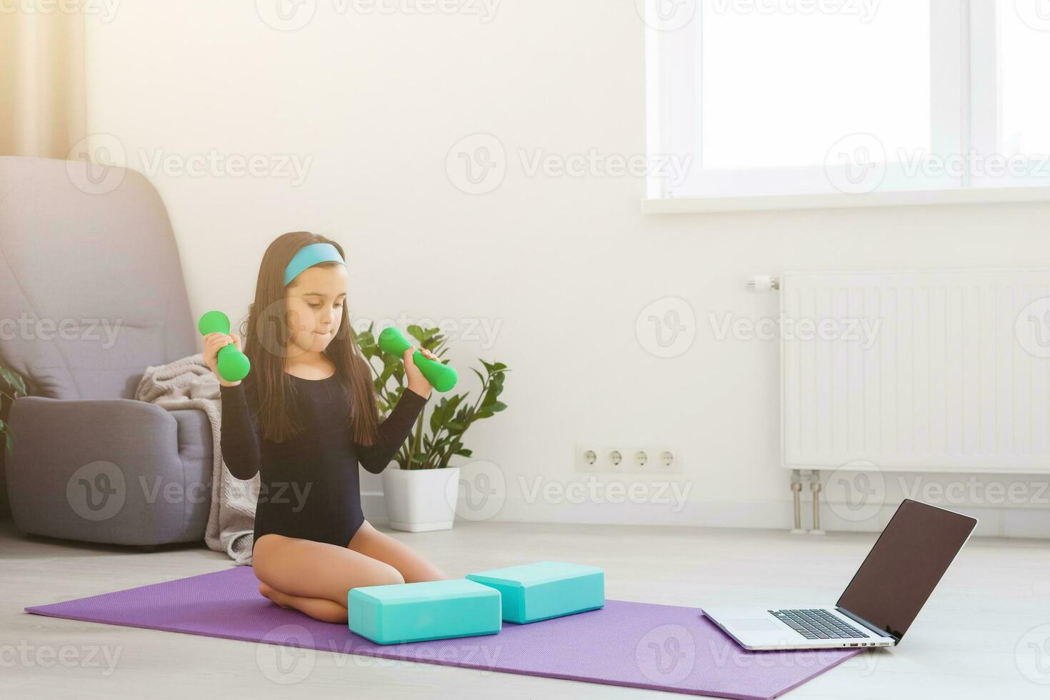 Quarantine at home. little girl do yoga during self isolation quarantine photo