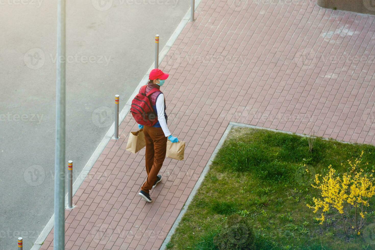 food delivery man on empty street producer of quarantine photo