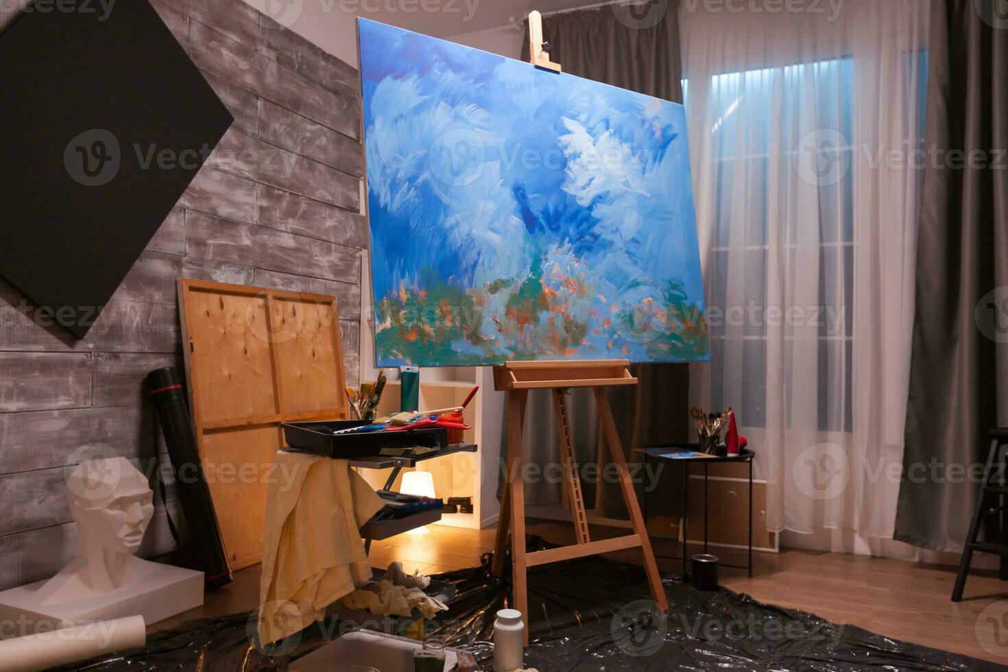 Interior of painting studio with wooden easel and blank canvas. Modern artwork paint on canvas, creative, contemporary and successful fine art artist drawing masterpiece photo