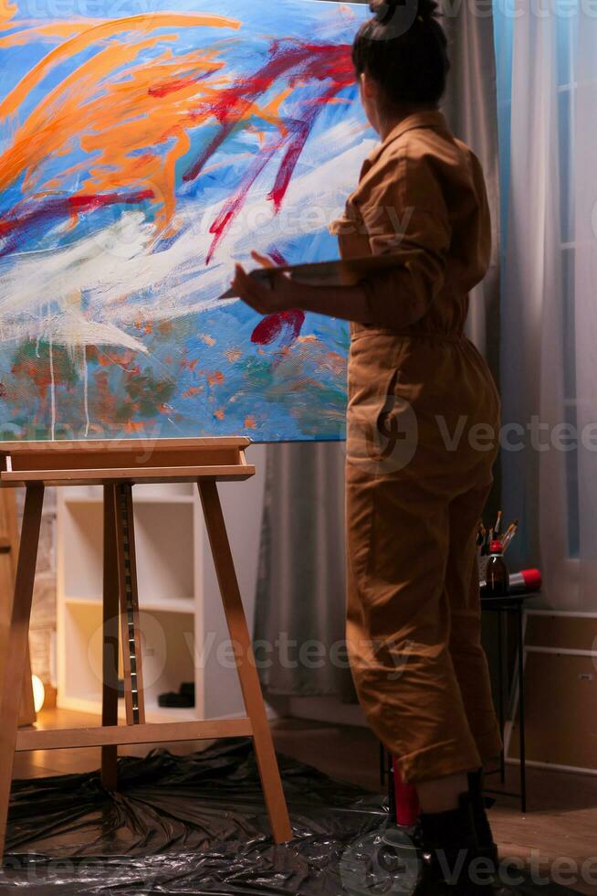 Painter in art studio using creativity to realize a successful painting. Modern artwork paint on canvas, creative, contemporary and successful fine art artist drawing masterpiece photo