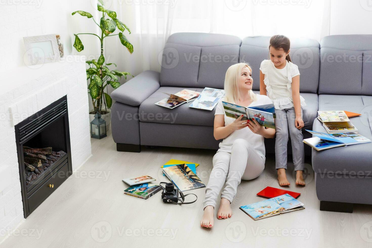 Young Happy Woman Looking At photobook In Her Room photo